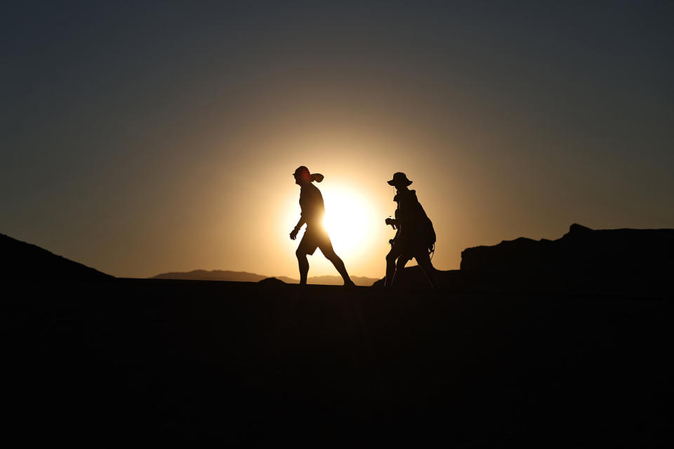 People brave the heat before sunset during a long-lasting heat wave in Death Valley National Park, California. (Mario Tama/Getty Images)