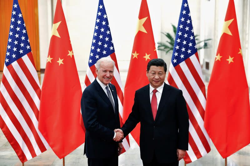 FILE PHOTO: Chinese President Xi Jinping shakes hands with U.S. Vice President Joe Biden inside the Great Hall of the People in Beijing