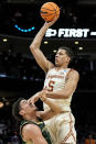 Texas forward Kadin Shedrick (5) shoots against Colorado State forward Joel Scott (1) during the first half of a first-round college basketball game in that NCAA Tournament, Thursday, March 21, 2024, in Charlotte, N.C. (AP Photo/Mike Stewart)