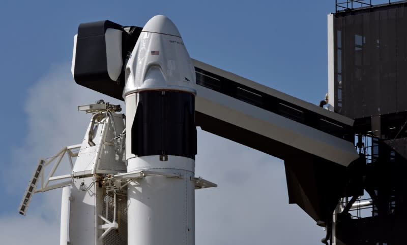 The SpaceX Crew Dragon capsule sits atop a Falcon 9 booster rocket on Pad 39A at Kennedy Space Center after a scheduled in-flight abort test was postponed due to poor weather offshore at Cape Canaveral