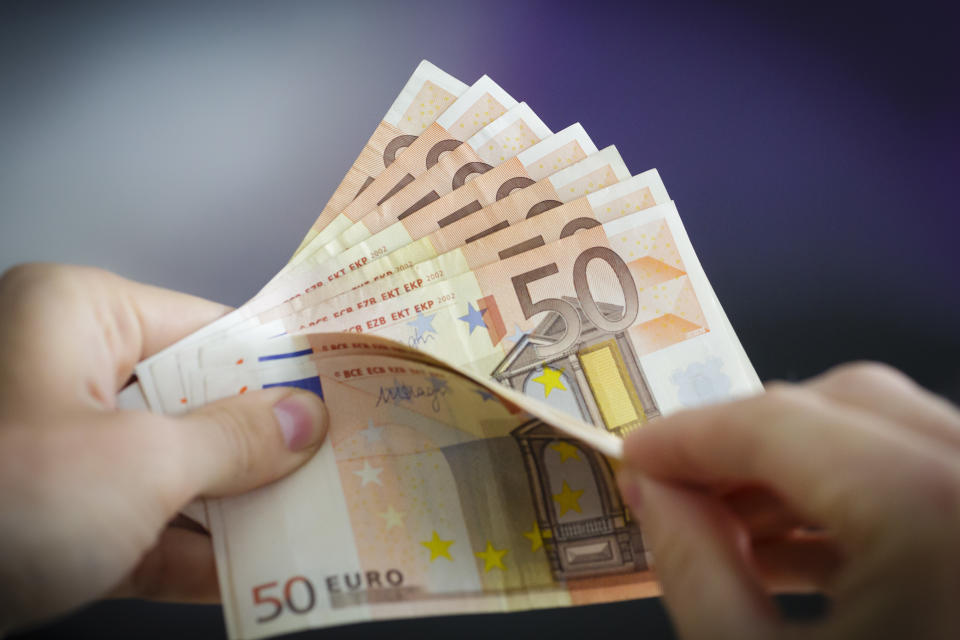 Berlin, Germany - August 03: In this Photo Illustration a person holds Euro banknotes on August 03, 2016 in Berlin, Germany. (Photo Illustration by Thomas Trutschel/Photothek via Getty Images)