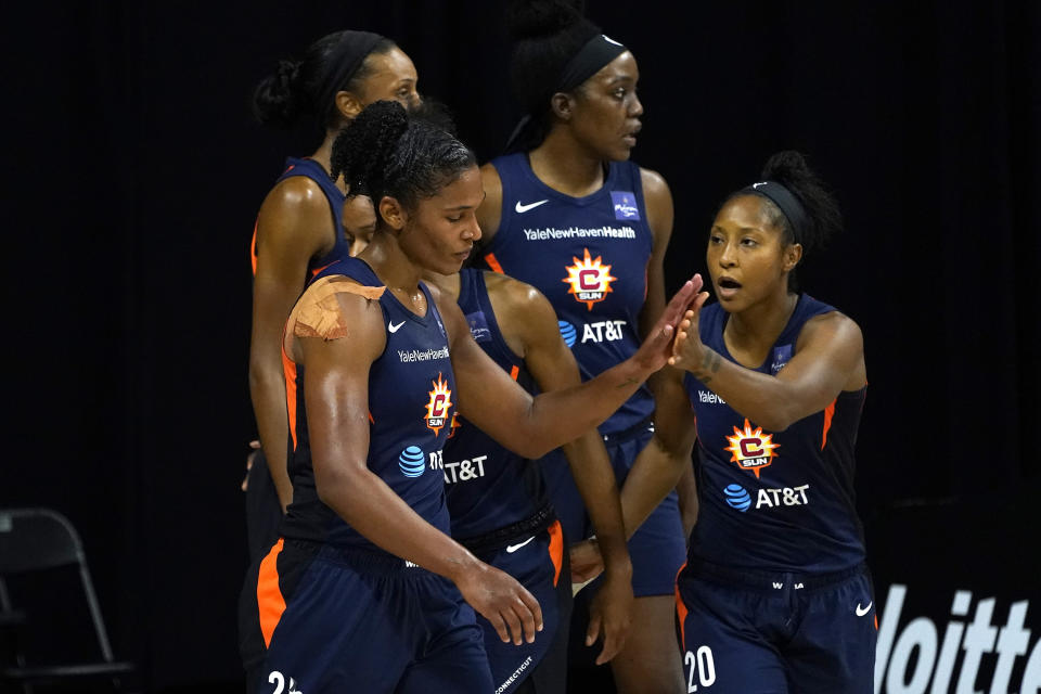 Connecticut Sun forward Alyssa Thomas (25) celebrates a basket against the Las Vegas Aces with guard Briann January (20) during the first half of Game 3 of a WNBA basketball semifinal round playoff series Thursday, Sept. 24, 2020, in Bradenton, Fla. (AP Photo/Chris O'Meara)