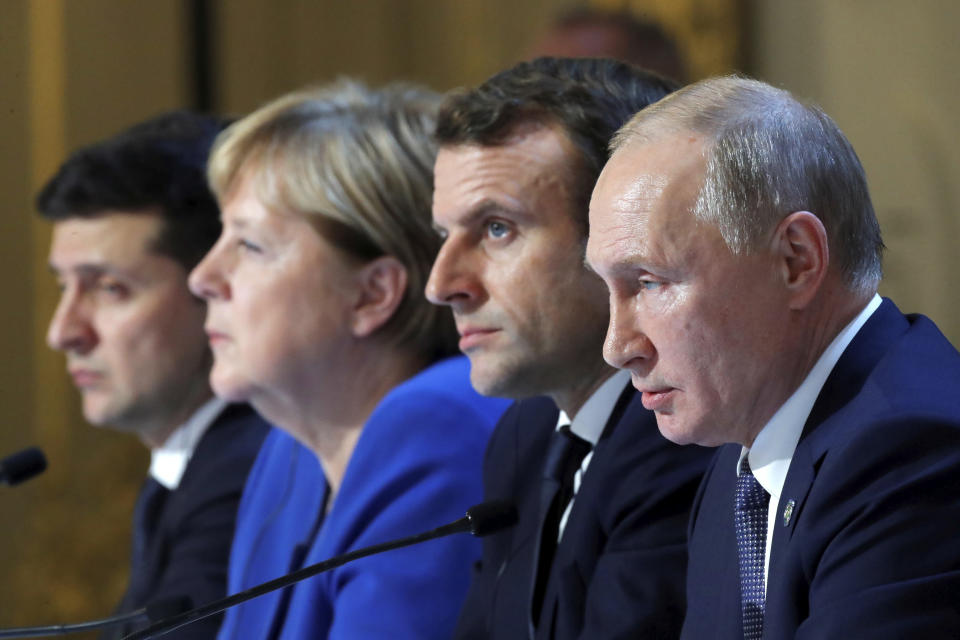 Ukraine's President Volodymyr Zelenskiy, left, German Chancellor Angela Merkel, French President Emmanuel Macron, third left and Russian President Vladimir Putin, right, attend a joint news conference at the Elysee Palace in Paris, Monday Dec. 9, 2019. Russian President Vladimir Putin and Ukrainian President Volodymyr Zelenskiy met for the first time Monday at a summit in Paris to try to end five years of war between Ukrainian troops and Russian-backed separatists. (Charles Platiau/Pool via AP)