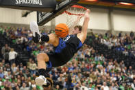 BYU forward Caleb Lohner dunks against Utah Valley in the first half during an NCAA college basketball game Wednesday, Dec. 1, 2021, in Orem, Utah. (AP Photo/Rick Bowmer)