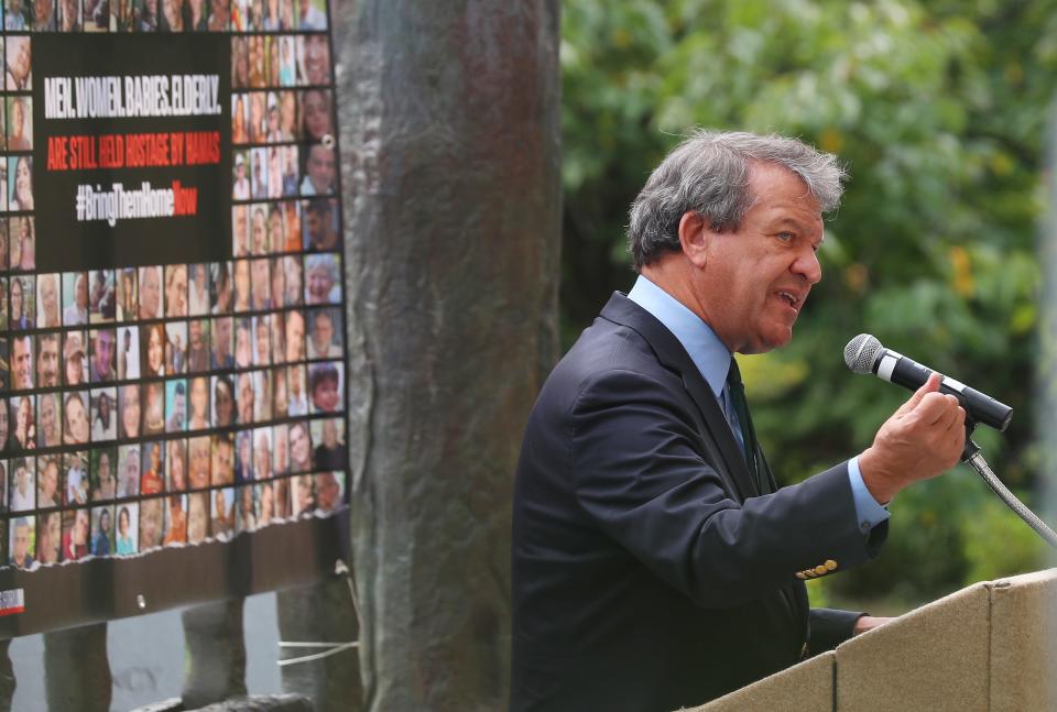 Westchester County Executive George Latimer speaks during a Bring Them Home Vigil in the Garden of Remembrance in White Plains as the Westchester community calls for the immediate release of the hostages held by Hamas Oct. 24, 2023. Photos of all the hostages are posted behind the county executive.