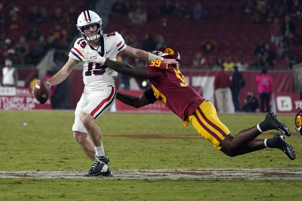 Arizona quarterback Will Plummer (15) is pressured by Southern California linebacker Drake Jackson during the second half of an NCAA college football game Saturday, Oct. 30, 2021, in Los Angeles. (AP Photo/Marcio Jose Sanchez)