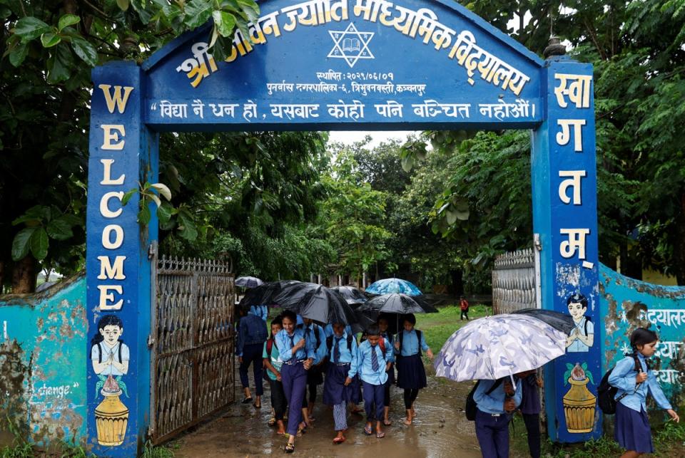 Parwati and her son Resham, 11, leave school to walk home (Reuters)