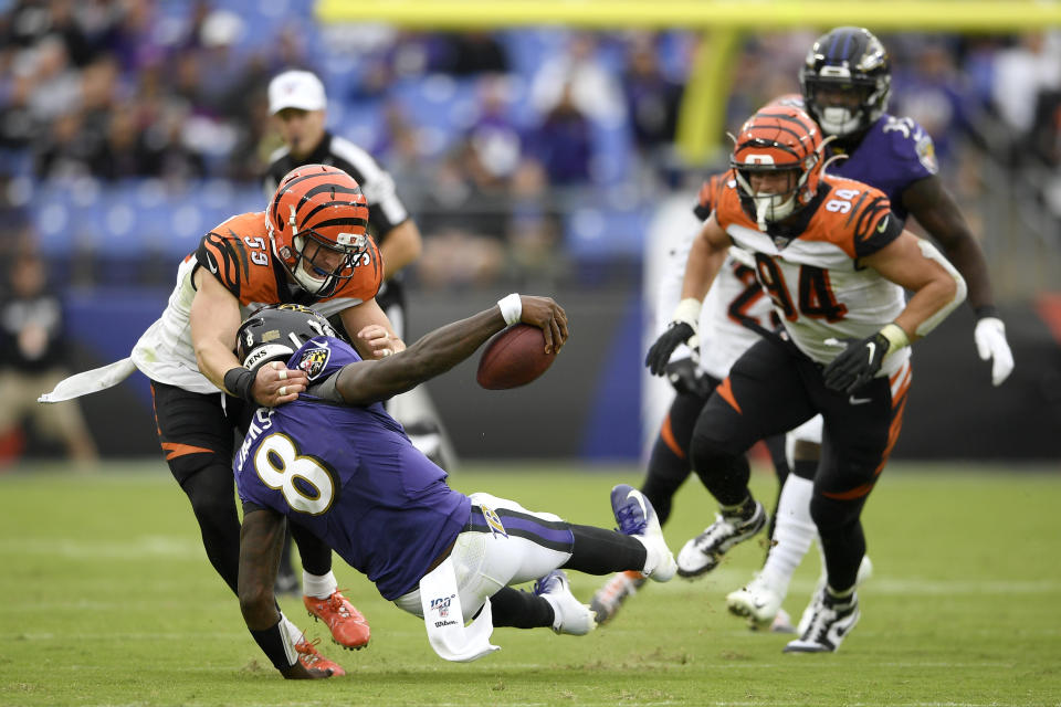 Cincinnati Bengals outside linebacker Nick Vigil (59) makes a hit on Baltimore Ravens quarterback Lamar Jackson (8) during the second half of a NFL football game Sunday, Oct. 13, 2019, in Baltimore. (AP Photo/Nick Wass)