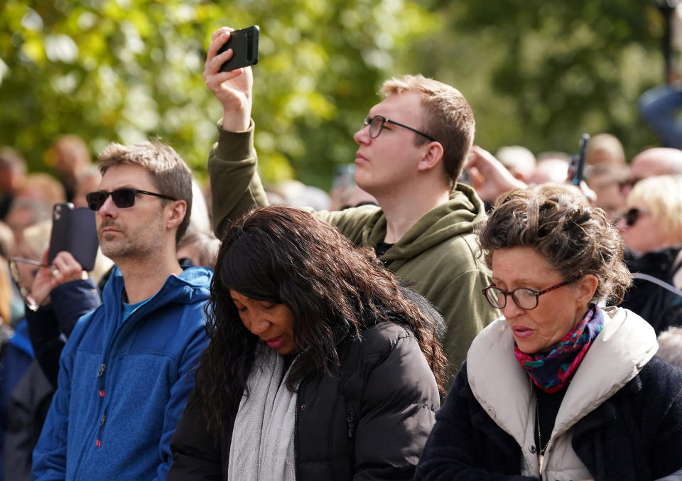 Members of the public on the Mall listen to the State Funeral of Queen Elizabeth II, held at Westminster Abbey, London. Picture date: Monday September 19, 2022.