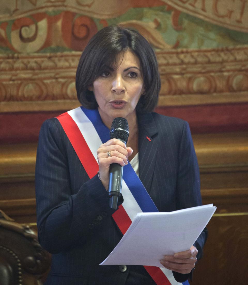 The new mayor of Paris Anne Hidalgo, wearing the mayoral sash in the color of the French Republic, speaks after her election, in Paris, Saturday, April 5, 2014. The first woman mayor of Paris has taken office, hailing a “great advance for all women” and saying she feels the weight of responsibility in her new job. (AP Photo/Michel Euler)