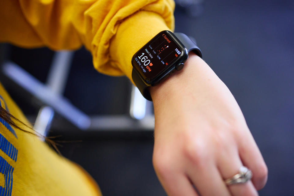 Since being diagnosed with POTS, Kaleigh Levine checks her heart rate while exercising in the gym. (Angelo Merendino for The Washington Post)