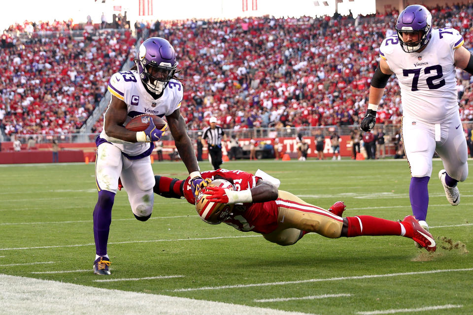 SANTA CLARA, CALIFORNIA - NOVEMBER 28: Dalvin Cook #33 of the Minnesota Vikings runs with the ball against Azeez Al-Shaair #51 of the San Francisco 49ers in the third quarter at Levi's Stadium on November 28, 2021 in Santa Clara, California. (Photo by Ezra Shaw/Getty Images)