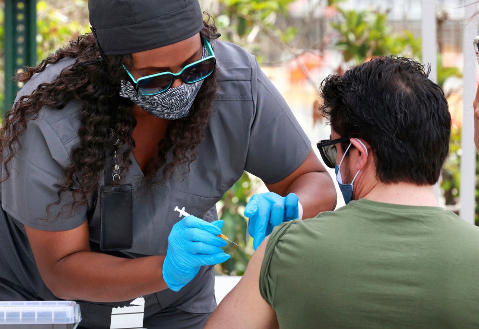 In this June 17, 2021, file photo, an Orange County resident receives the COVID-19 vaccine at the Florida Division of Emergency Management mobile vaccination site at Camping World Stadium in Orlando, Fla.