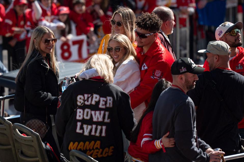 At center, Kansas City Chiefs quarterback Patrick Mahomes celebrates with his wife, Brittany Mahomes, during the parade.<span class="copyright">Amy Kontras—AFP/Getty Images</span>