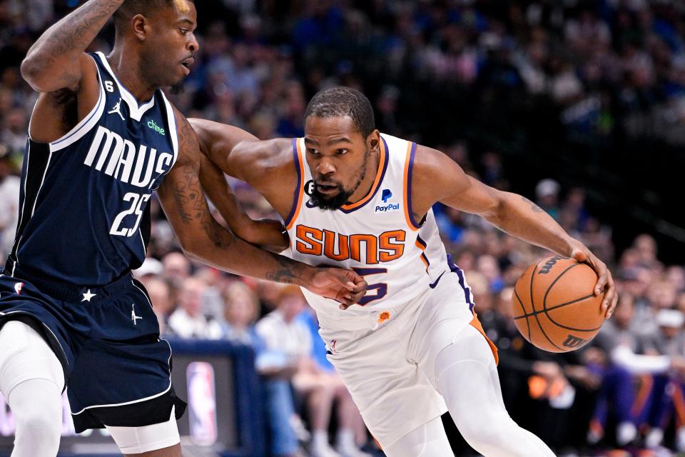 Phoenix Suns forward Kevin Durant (35) brings the ball up court past Dallas Mavericks forward Reggie Bullock (25) during the first quarter at the American Airlines Center in Dallas on March 5, 2023.