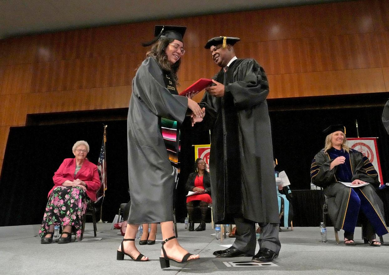 Anahi Palacios, majoring in computer science gets her diploma from Gerard Randall, the co-chair of the Cardinal Stritch University board of trustees, at the last commencement ceremony for Cardinal Stritch University at the Wisconsin Center Milwaukee on Sunday. The Fox Point university announced last month it was closing its doors for good at the end of spring semester.