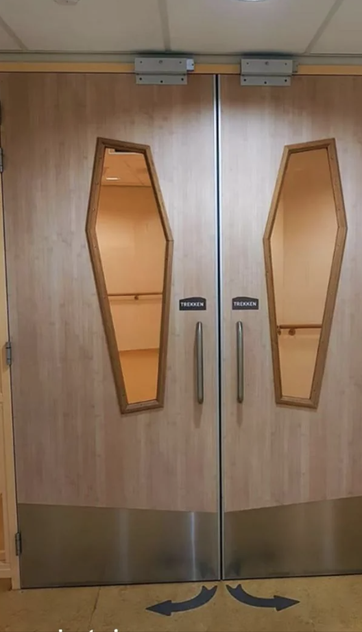 Elevator doors with coffin-shaped windows reflecting the Internet's interest in quirky designs