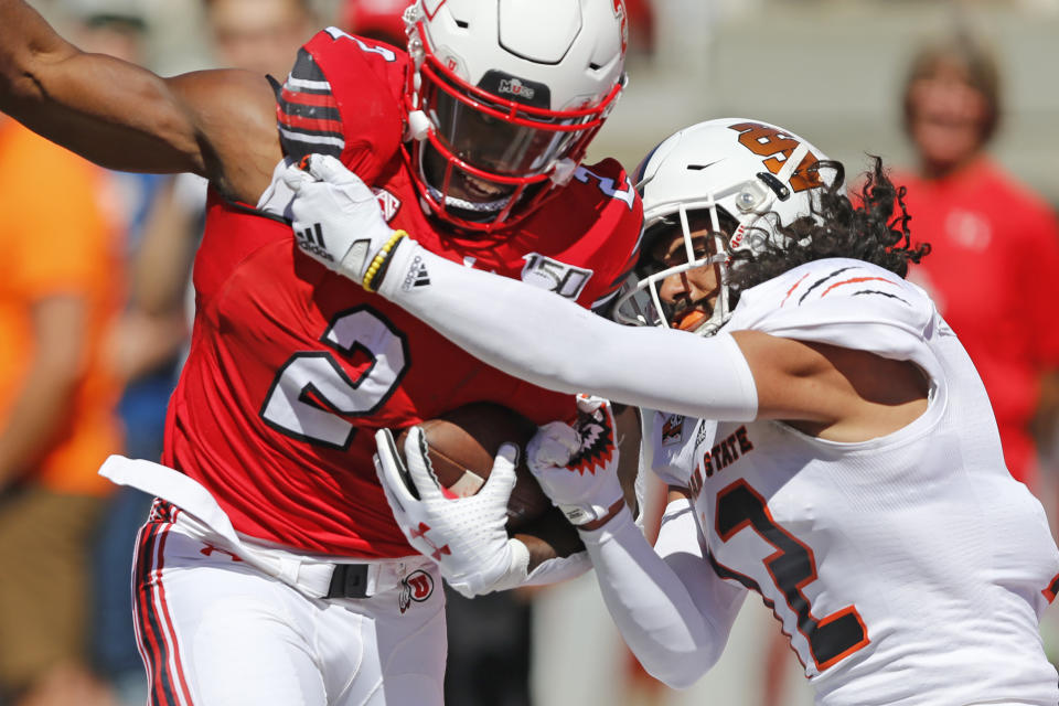 Utah running back Zack Moss (2) is tackled by Idaho State defensive back Adkin Aguirre (12) in the first half of an NCAA college football game Saturday, Sept. 14, 2019, in Salt Lake City. (AP Photo/Rick Bowmer)