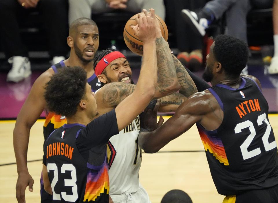 Apr 26, 2022; Phoenix, Ariz, U.S.;  New Orleans Pelicans forward Brandon Ingram (14) is trapped by Phoenix Suns forward Cameron Johnson (23) and center Deandre Ayton (22) during Game 5 of the Western Conference playoffs.