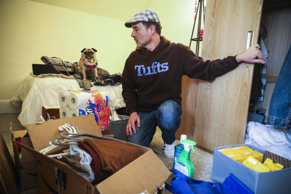 SOMERVILLE, MA - MARCH 12: Tufts University student Mark Beckwith becomes overwhelmed while packing up his dorm room with his service dog, Matilda, at his side on March 12, 2020 in Somerville, MA. In the wake of the continued increase of coronavrius cases statewide, Tufts University closed their campus and asked students to leave their student housing by Sunday. Beckwith, however, has significant health and financial considerations that would make leaving campus virtually impossible. Although he has applied for an exemption from Tufts administration that would allow him to stay, he won't know until the weekend and must pack his belongings while he waits for the news. (Photo by Erin Clark for The Boston Globe via Getty Images)