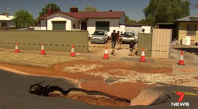 A giant sinkhole opened up outside one family's house. Source: 7 News