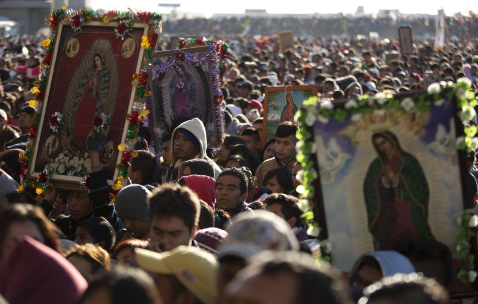 FILE - Pilgrims wait their turn to enter the Basilica of Guadalupe, in Mexico City, Dec. 12, 2013. Hundreds of thousands of people from all over the country converge on Mexico's holy Roman Catholic site, many bringing with them images or statues of Mexico's patron saint to be blessed, marking the Virgin's Dec. 12 feast day. (AP Photo/Eduardo Verdugo, File)