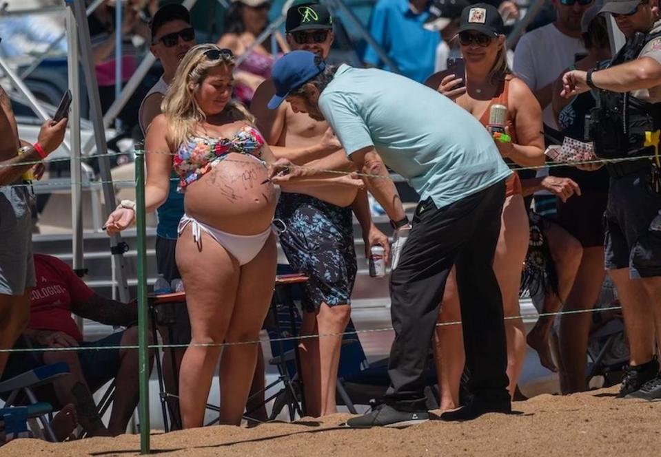 Billie Kirk of Lincoln has her belly autographed on Friday, July 14, 2023 by actor Ray Romano as he participates in the American Century Championship at Edgewood Tahoe Golf Course.