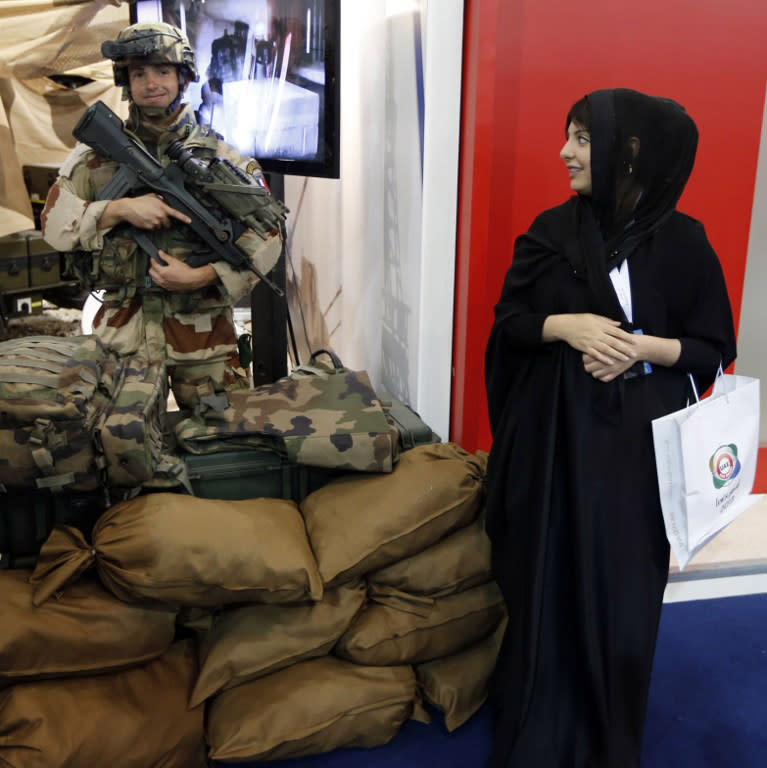 An Emirati woman looks over at a French soldier during the launching of the International Defence Exhibition and Conference (IDEX) at the Abu Dhabi National Exhibition Centre in the Emirati capital on February 17, 2013. A top French defence industry official said that talks to sell Rafale jet fighters to the UAE were "progressing well", expressing confidence that a deal could be reached with the Gulf state.