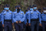 Honduran police stand guard at the crossing border with Guatemala, in El Florido, Honduras, Saturday, Jan. 16, 2021. Migrants pushed their way into Guatemala Friday night without registering, a portion of a larger migrant caravan that had left the Honduran city of San Pedro Sula before dawn, Guatemalan authorities said. (AP Photo/Sandra Sebastian)