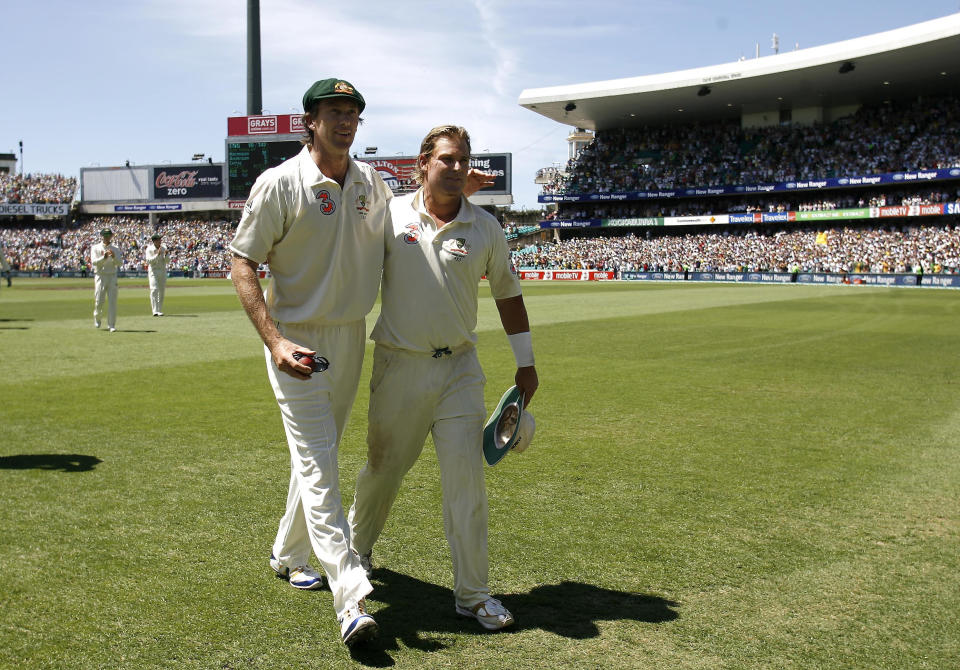 Glenn McGrath (pictured left) and Shane Warne (pictured right) walk off the SCG.