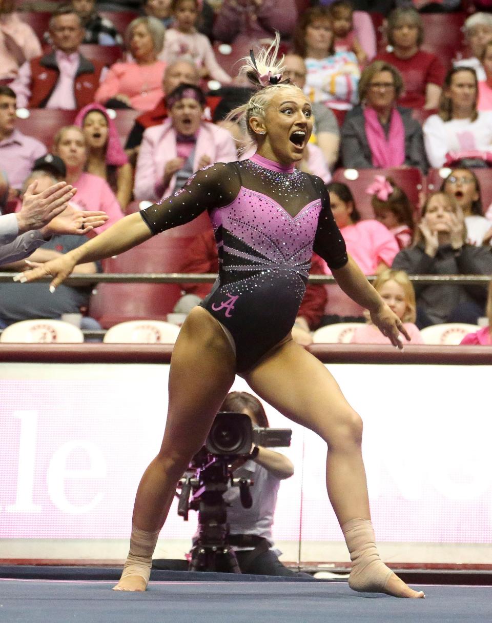 Alabama gymnast Lexi Graber reacts after sticking the landing on a tumbling pass on the floor in the Power of Pink meet with the University of Georgia Friday, Feb. 11, 2022, in Coleman Coliseum. Alabama won the meet with a score of 197.475 to 196.800.