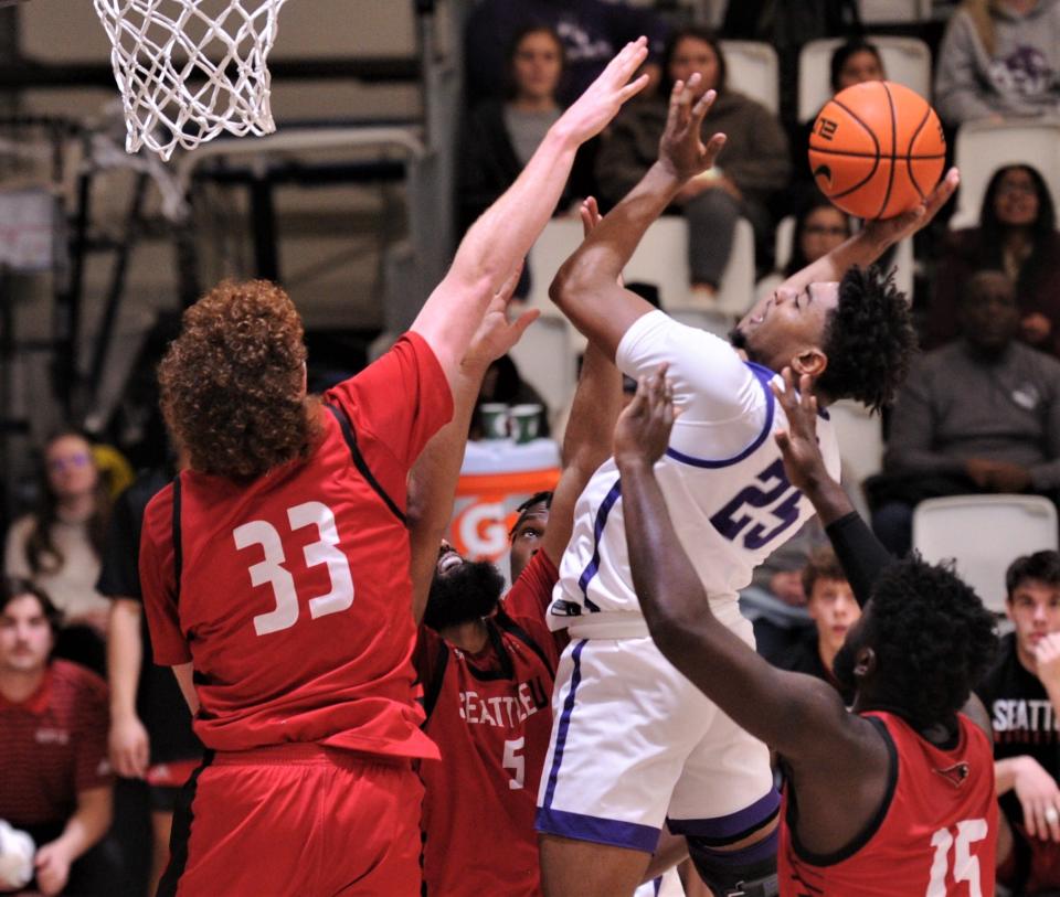 CU's Immanuel Allen (25) drives against Seattle's Kobe Williamson (33), Emeka Udenyi (15) and Cameron Tyson in the first half.