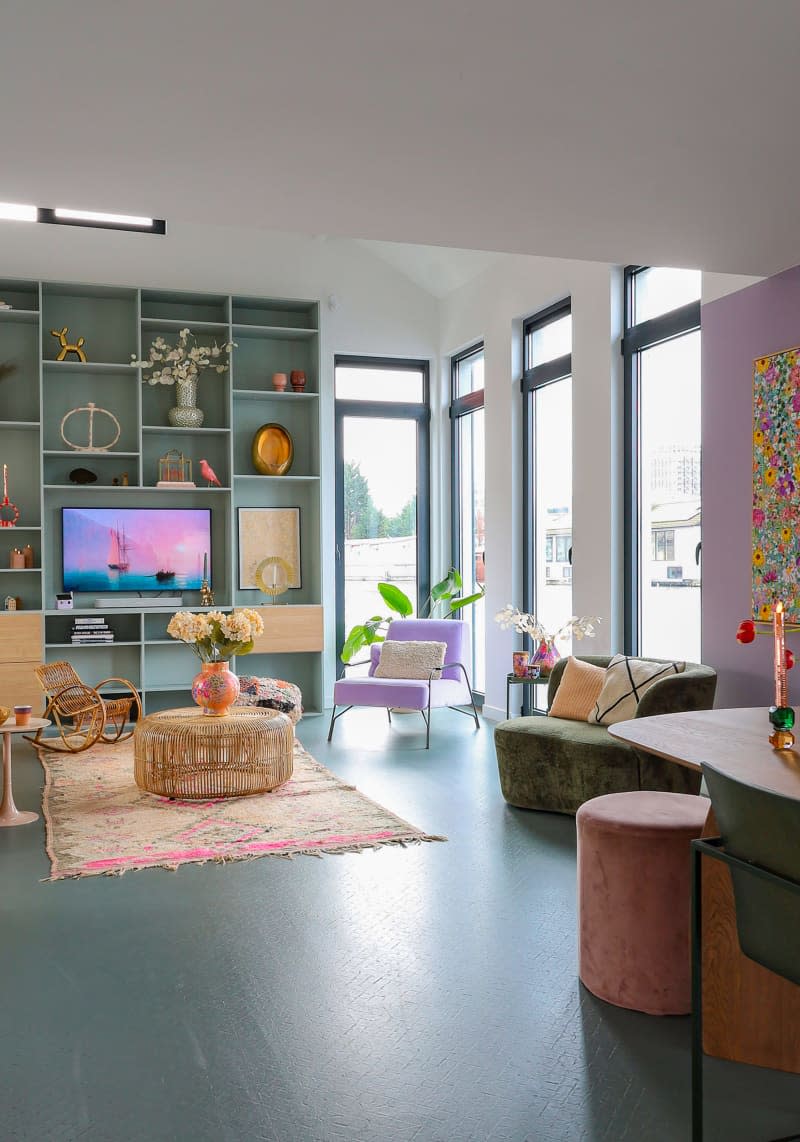 View of living room with sky blue wall unit.