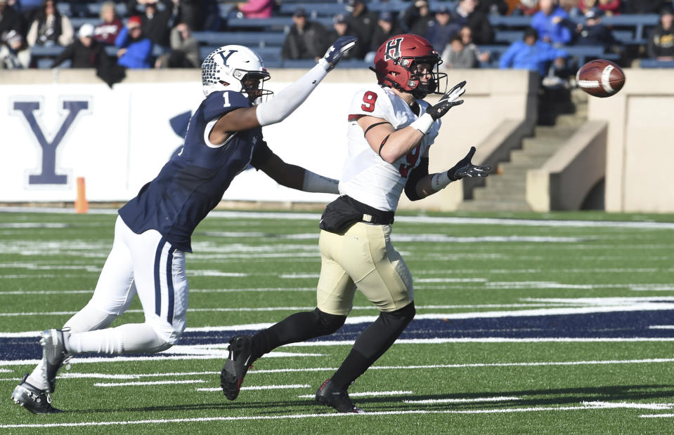 Harvard's Cody Chrest makes a reception as Yale's Malcolm Dixon defends during the first half during an NCAA college football game, Saturday, Nov. 23, 2019, in New Haven, Conn. (Arnold Gold/New Haven Register via AP)