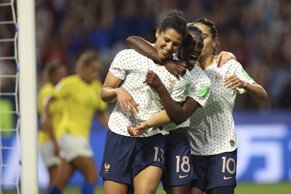 France's Valerie Gauvin, left, celebrates with France's Viviane Asseyi, center, and France's Amel Majri after scoring her side's first goal during the Women's World Cup round of 16 soccer match between France and Brazil at the Oceane stadium in Le Havre, France, Sunday, June 23, 2019. (AP Photo/Francisco Seco)