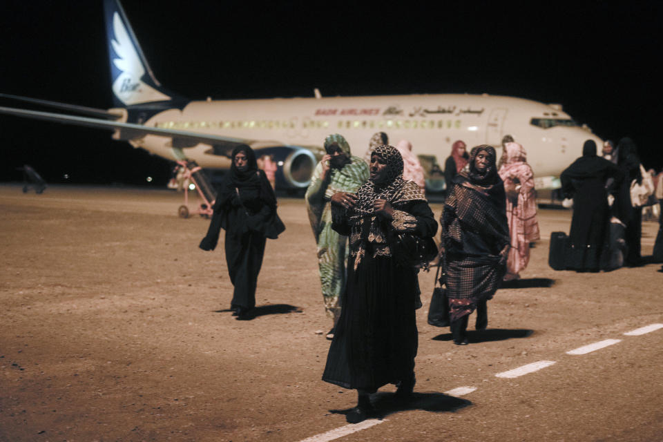 Sudanese, who had been stranded in Jeddah, Saudi Arabia, arrive at Port Sudan airport, Thursday, May 11, 2023. The conflict between the country's military and a rival paramilitary group has killed hundreds and displaced hundreds of thousands since it broke out in mid-April, creating a humanitarian crisis inside the country and at its borders. (AP Photo/Amr Nabil)