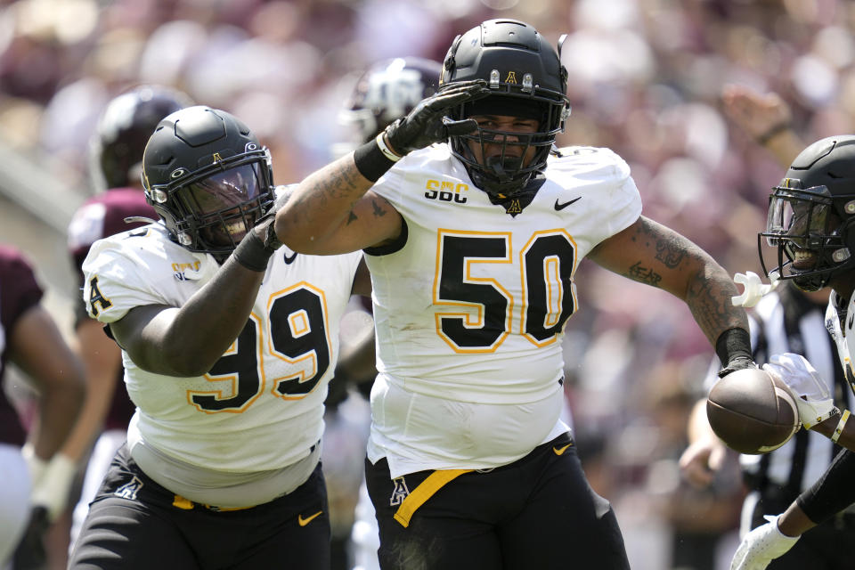 Appalachian State defensive lineman DeAndre Dingle-Prince (50) and teammate Jordon Earle (99) react after recovering a fumble by Texas A&M quarterback Haynes King during the first quarter of an NCAA college football game Saturday, Sept. 10, 2022, in College Station, Texas. (AP Photo/Sam Craft)