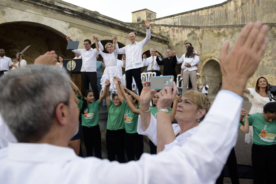 Florida Gov. Rick Scott, top center, attends a ceremony marking the one year anniversary of Hurricane Maria at the San Cristobal Castle in San Juan, Puerto Rico, Thursday, Sept. 20, 2018. People gathered to remember the thousands who died in the aftermath of Hurricane Maria as the U.S. territory struggles to recover one year after the Category 4 storm hit. (AP Photo Carlos Giusti)