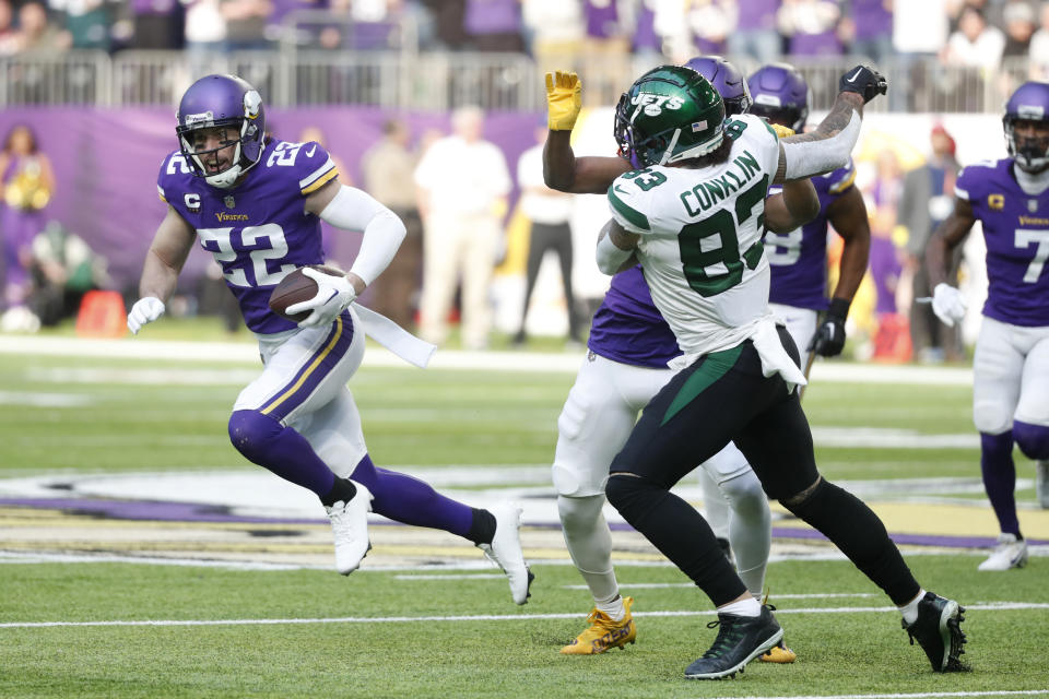 Minnesota Vikings safety Harrison Smith (22) runs from New York Jets tight end Tyler Conklin (83) after intercepting a pass during the first half of an NFL football game, Sunday, Dec. 4, 2022, in Minneapolis. (AP Photo/Bruce Kluckhohn)