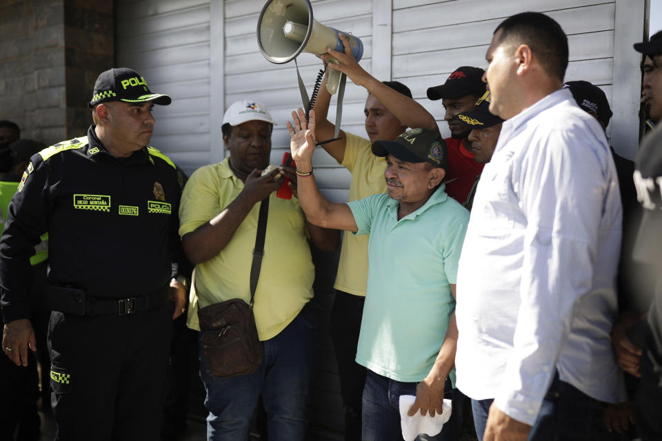 Luis Manuel Díaz raises his arm as he speaks to neighbors at his home in Barrancas, Colombia, after after he was released by his kidnappers Thursday, Nov. 9, 2023. Díaz, the father of Liverpool striker Luis Díaz, was kidnapped on Oct. 28 by the guerrilla group National Liberation Army, or ELN. (AP Photo/Ivan Valencia)