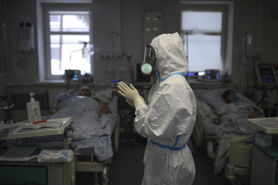 A medical staff member prepares to treat a patient with COVID-19 at an ICU of a hospital in Krasnodar, southern Russia, Thursday, Jan. 27, 2022. Russia has confirmed 11,404,617 cases of coronavirus and 328,770 deaths, according to the national coronavirus information center. Russia's total excess fatality count since the start of the coronavirus pandemic is at least 929,000. Under half the population is fully vaccinated. (AP Photo/Vitaliy Timkiv)
