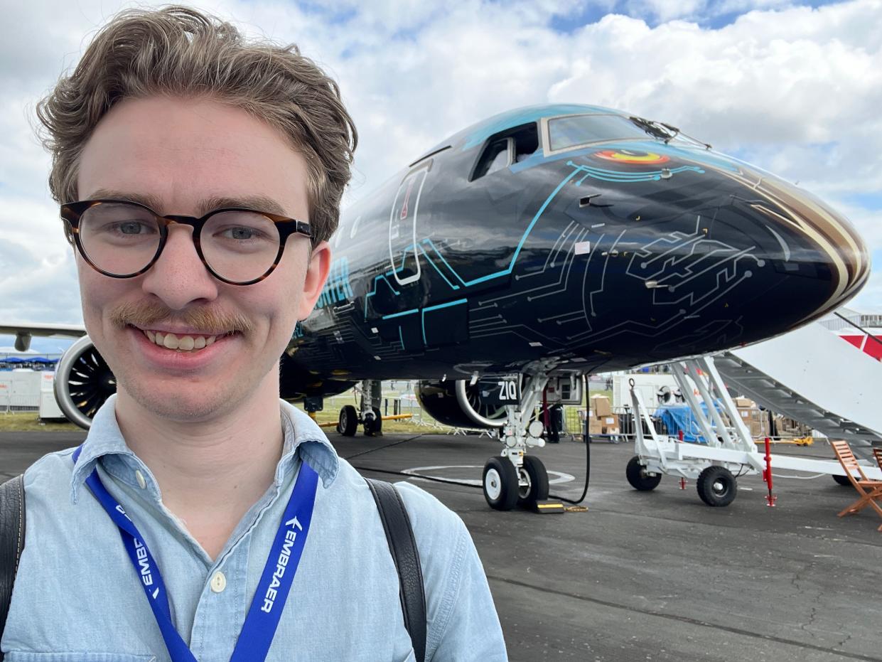 The author takes a selfie in front of an Embraer E195-E2 at the 2024 Farnborough Airshow