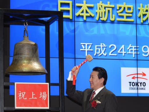 Japan Airlines Co. president Yoshiharu Ueki rings the bell during the company's relisting ceremony on the Tokyo Stock Exchange's First Section in Tokyo on September 19. The firm finished Friday at 3,680 yen, below the 3,790 yen it opened at on the Tokyo Stock Exchange Wednesday as it returned to the bourse less than three years after becoming one of Japan's biggest ever corporate failures