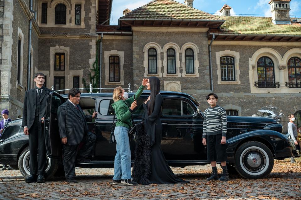 The butler Lurch (George Burcea), Gomez (Luis Guzmán), Morticia (Catherine Zeta-Jones), and Pugsley (Issac Ordonez) visit Nevermore Academy for Parents' Weekend.<span class="copyright">Vlad Cioplea—Netflix</span>