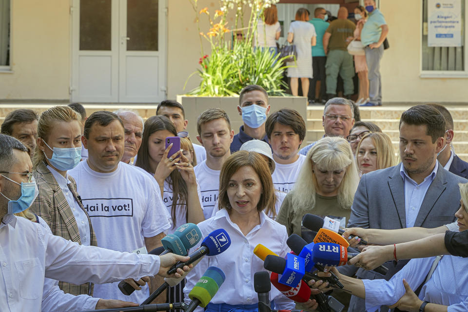 Moldova's President Maia Sandu speaks to the media after casting her vote in a snap parliamentary election, in Chisinau, Moldova, Sunday, July 11, 2021. Moldovan citizens vote in a key snap parliamentary election that could decide whether the former Soviet republic fully embraces pro-Western reform or prolongs a political impasse with strong Russian influence. (AP Photo/Aurel Obreja)