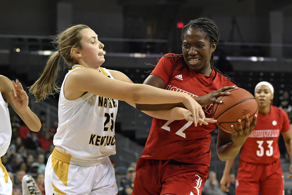 Northern Kentucky guard Ally Niece (25) battles Louisville forward Elizabeth Dixon (22) for the ball during the first half of an NCAA college basketball game in Highland Heights, Ky., Sunday, Dec. 8, 2019. (AP Photo/Timothy D. Easley)