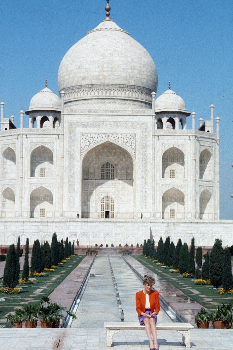 AGRA, INDIA - FEBRUARY 11: Daiana, Princess of Wales, wearing a red and purple suit designed by Catherine Walker, poses alone outside the Taj Mahal on February 11, 1992 in Agra, India. 12 years earlier her husband, Prince Charles, Prince of Wales, posed in the same spot. (Photo by Anwar Hussein/Getty Images)