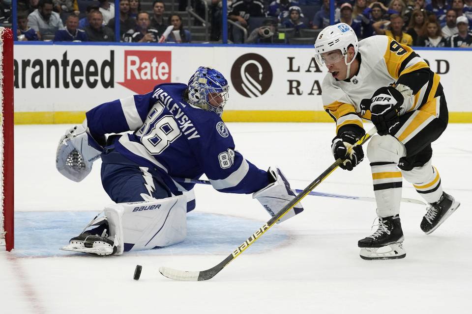 Pittsburgh Penguins center Evan Rodrigues (9) loses control of the puck as he attempts to get a shot on Tampa Bay Lightning goaltender Andrei Vasilevskiy (88) during the first period of an NHL hockey game Tuesday, Oct. 12, 2021, in Tampa, Fla. (AP Photo/Chris O'Meara)