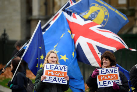 Pro-Brexit and anti-Brexit protesters hold posters and flags in Whitehall, in central London, Britain December 6, 2018. REUTERS/ Toby Melville