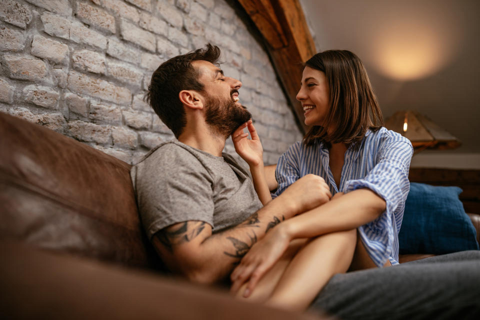 Shot of a happy young couple cuddling in the living room